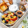 pastries and fruit in a hamper with flowers