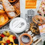 pastries and fruit in a hamper with flowers