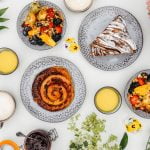 pastries and fruit in a hamper with flowers