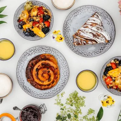 pastries and fruit in a hamper with flowers