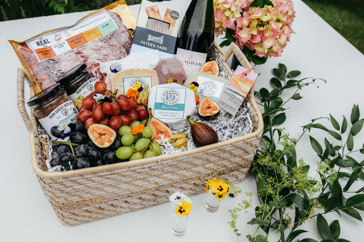 cheese grapes and wine in hamper