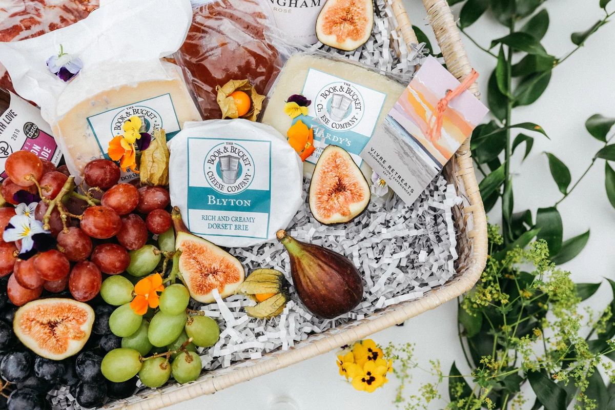 cheese grapes and wine in hamper
