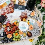 cheese grapes and wine in hamper