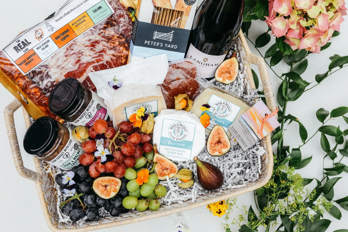 cheese grapes and wine in hamper