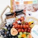 cheese grapes and wine in hamper