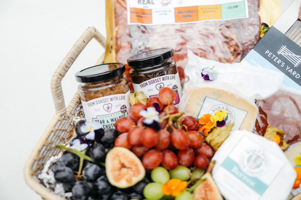 cheese grapes and wine in hamper
